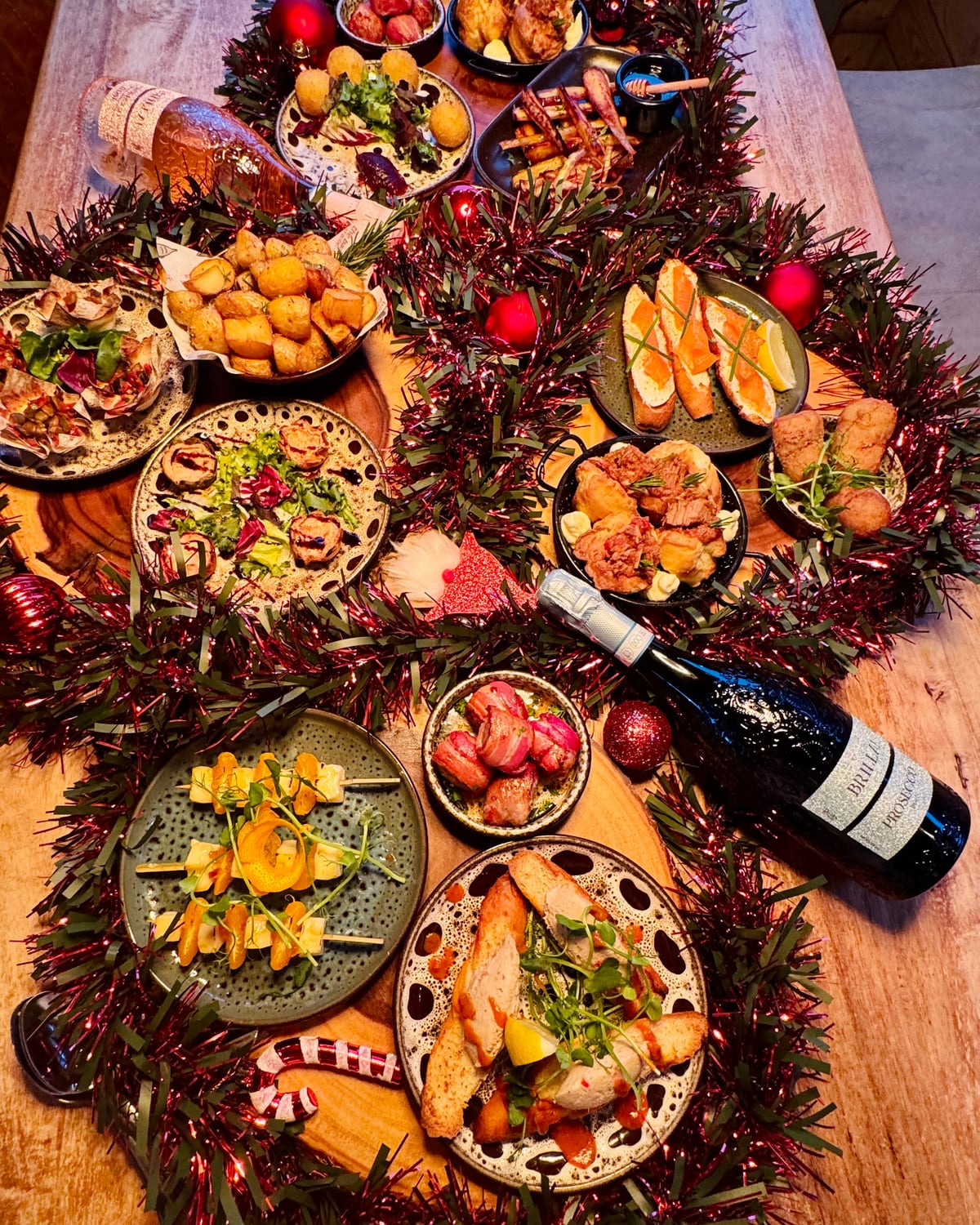 A festive tapas sharing feast dressed with tinsel and baubles on the table at The Bank at Bude