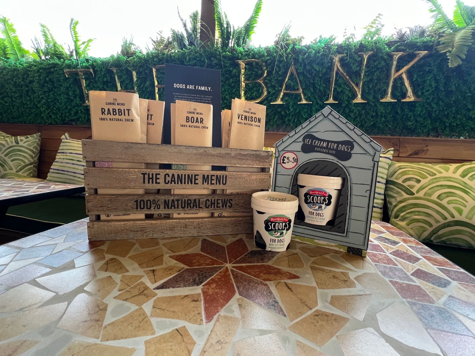 The Bank at Bude's ‘Dogs are family’ canine menu of natural chews and Scoops dog ice cream beneath the gold THE BANK lettering