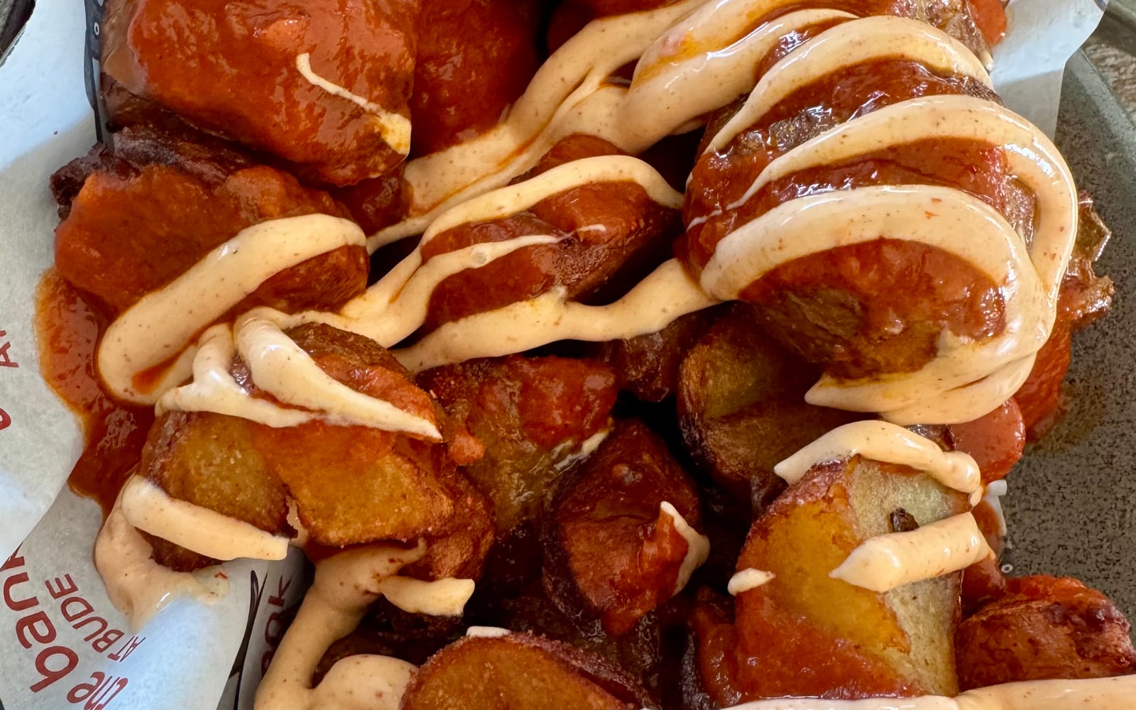 Crispy paprika patatas drizzled with bravas sauce and aioli at The Bank at Bude