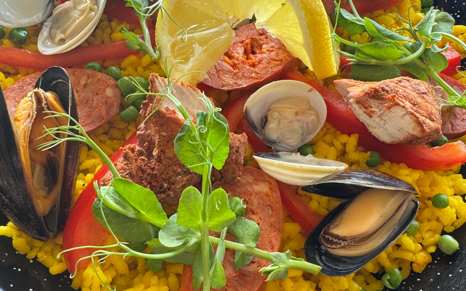 Saffron paella topped with chorizo, mussels, clams, belly pork and peppers at The Bank at Bude