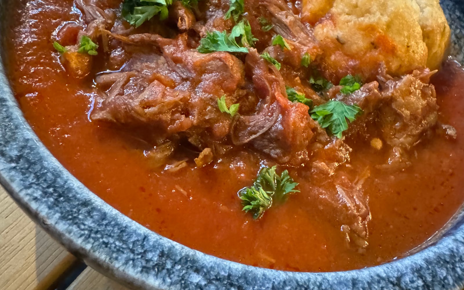 Slow cooked beef stew in a rich tomato sauce topped with a herby suet dumpling at The Bank at Bude