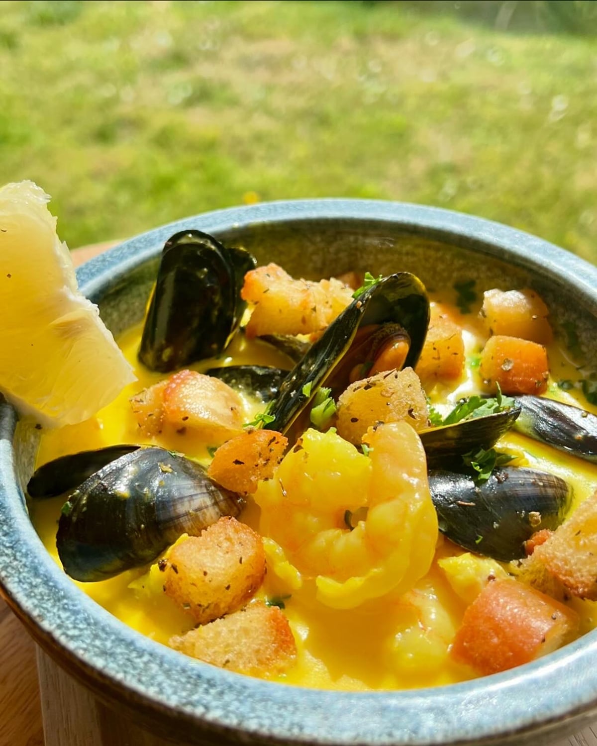 A bowl of creamy saffron seafood chowder with mussels, king prawns and herby croutons at The Bank at Bude