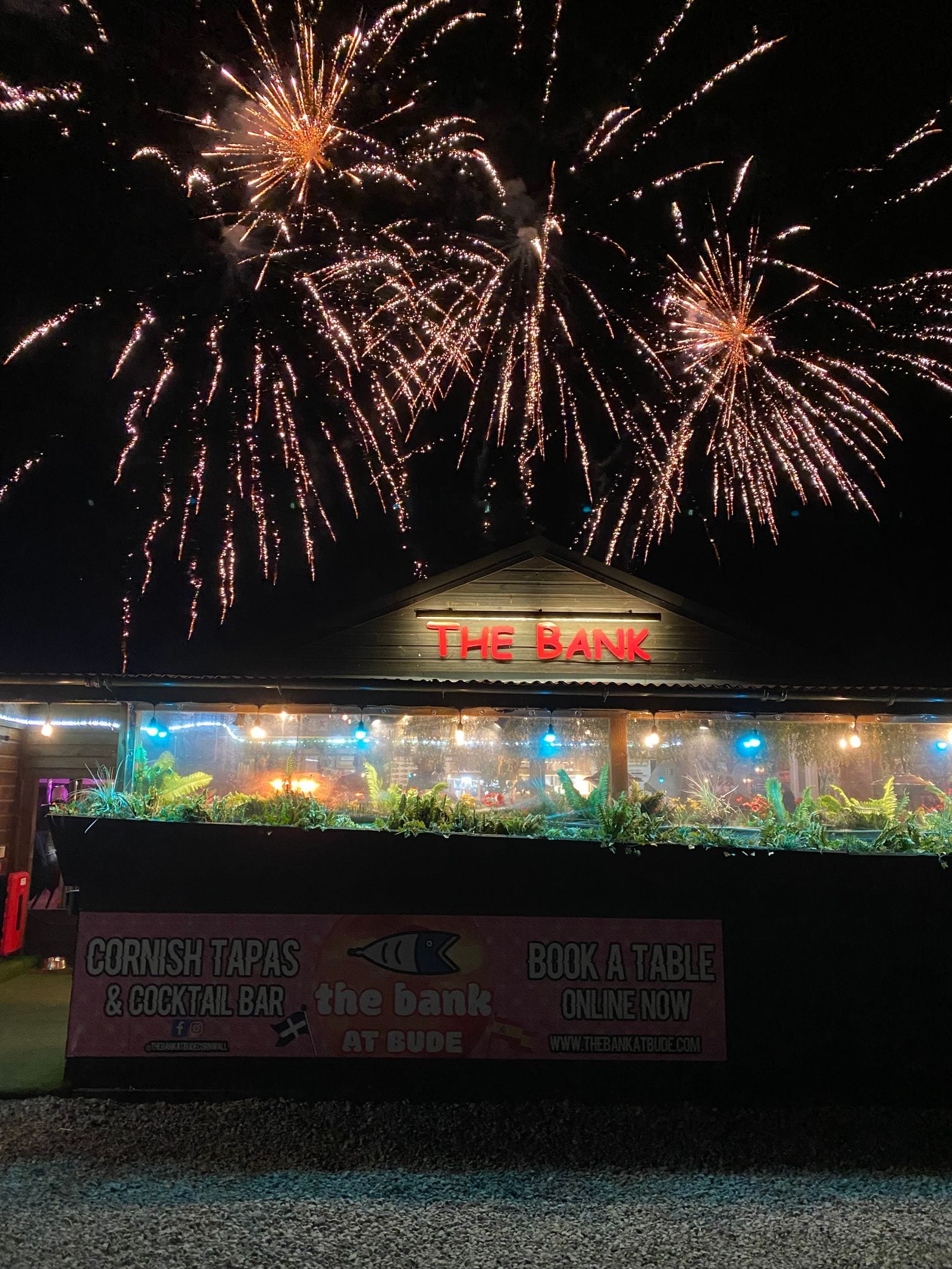 Fireworks bursting over The Bank at Bude above its “Cornish Tapas & Cocktail Bar” banner